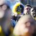 A Michigan fan wears a mask as he watches the jumbo screen during a Michigan pep rally at the Allstate Fan Fest in New Orleans, LA, on Monday.  Melanie Maxwell I AnnArbor.com
